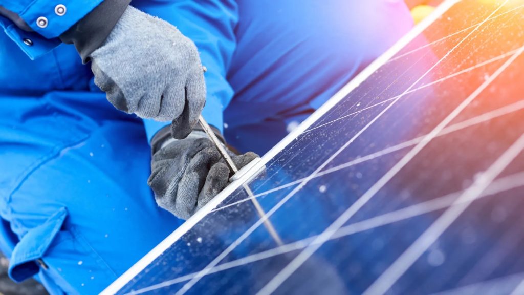 A photo of solar panels being mounted on the roof